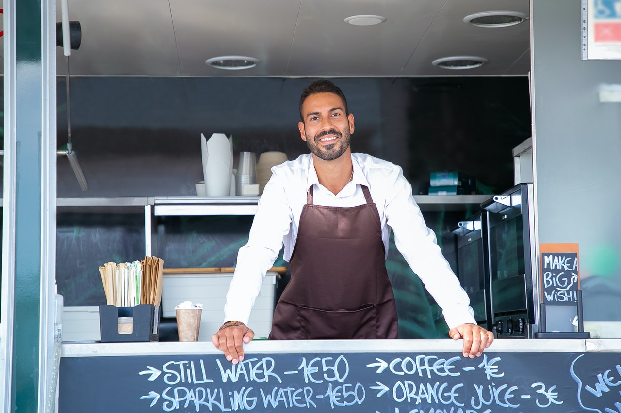 A person standing behind a café counter